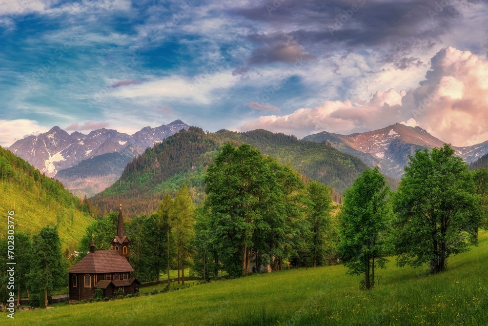 Beautiful landscape of the Tatra Mountains with a wooden church in the morning, High Tatras , Tatranska Javorina, Mountains Poland and Slovakia.