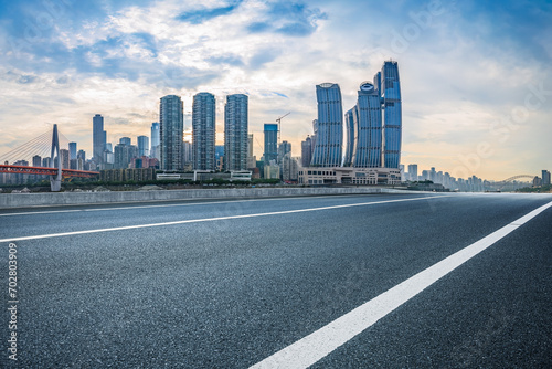 Empty asphalt road and city buildings skyline in Chongqing