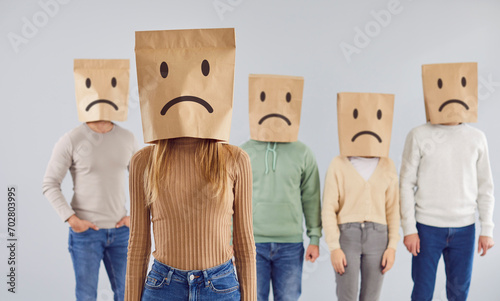 Canvas Print Diverse group of individuals wearing paper bags with drawn sad faces on heads, creating a unique and thought provoking portrait that reflects a shared sense of emotion and solidarity
