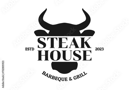Steak house logo. BBQ, grill, meat restaurant emblem. Steakhouse sign or icon design with bull or cow head. Vector illustration. photo