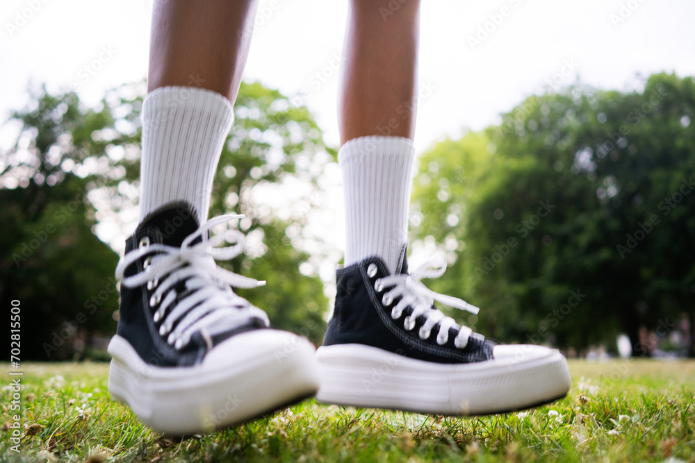 Stylish black sneakers on the grass