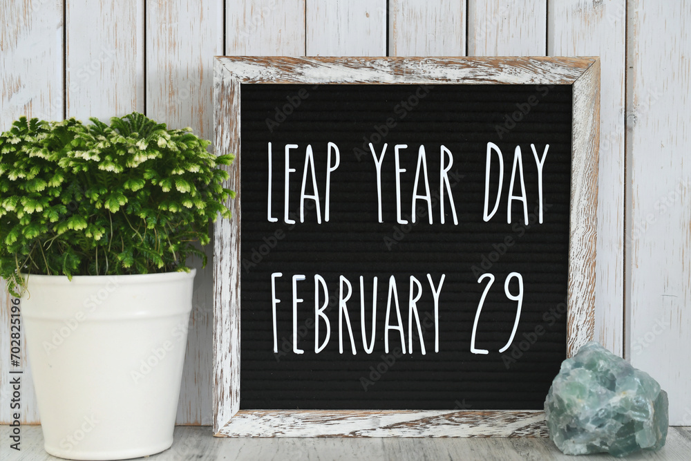 Leap Year Day, February 29, message board sign on desk - concept for event that happens every four years. - obrazy, fototapety, plakaty 