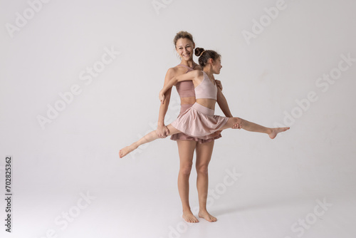 Wallpaper Mural Mother and daughter doing exercise on a white background, two girls do fitness Torontodigital.ca