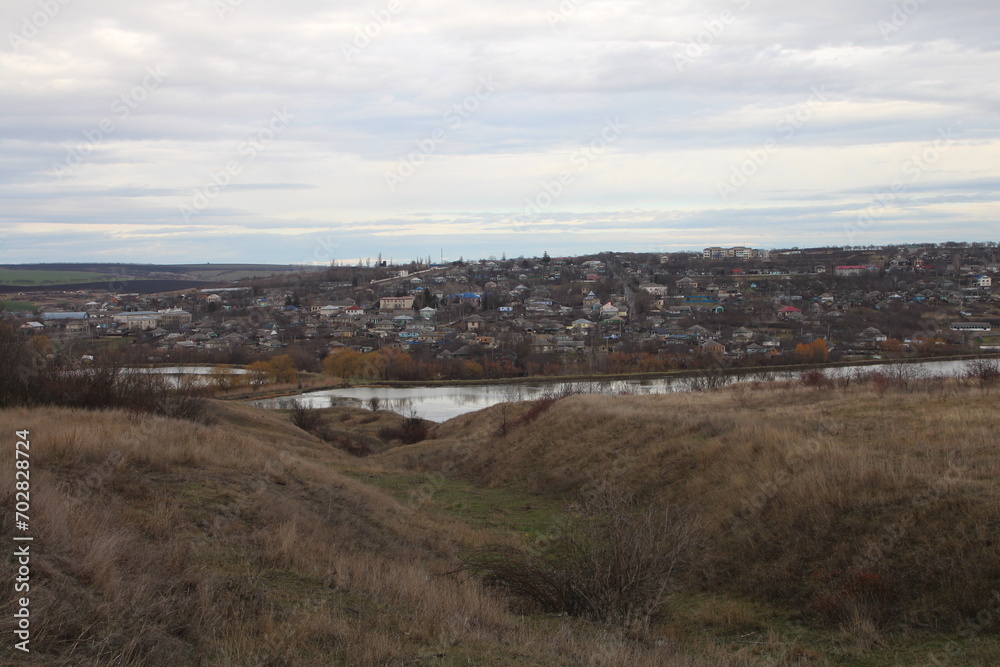 A landscape with a river and buildings