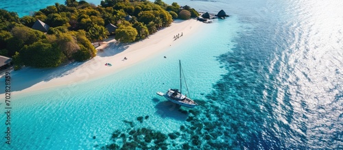 Luxury island landscape in Maldives Sail boat blue sea water horizon reef water villas Tropical beach amazing aerial seascape view from drone Beautiful nature people snorkel excursion recreatio photo
