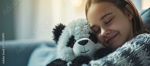 Happy woman smelling her freshly washed panda plush she just took it out from the washing machine. with copy space image. Place for adding text or design photo