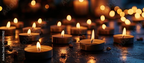Many candle flames glowing in the dark create a spiritual atmosphere. with copy space image. Place for adding text or design