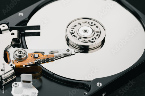 Hard drive isolated on white background. HDD. Major components of a 3.5-inch SATA hard disk drive: platter, spindle, actuator, actuator arm. Disk head above the plates