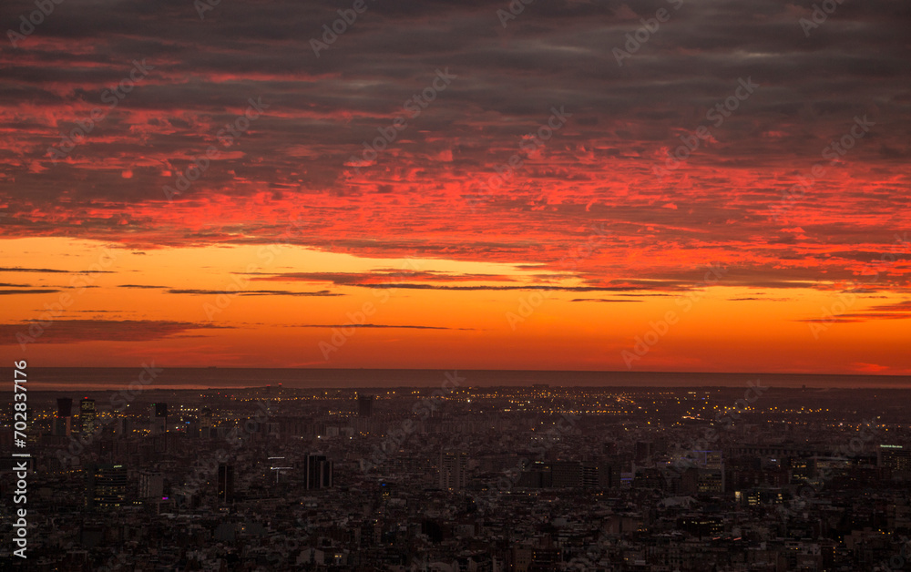 Glowing red sunset over Barcelona city