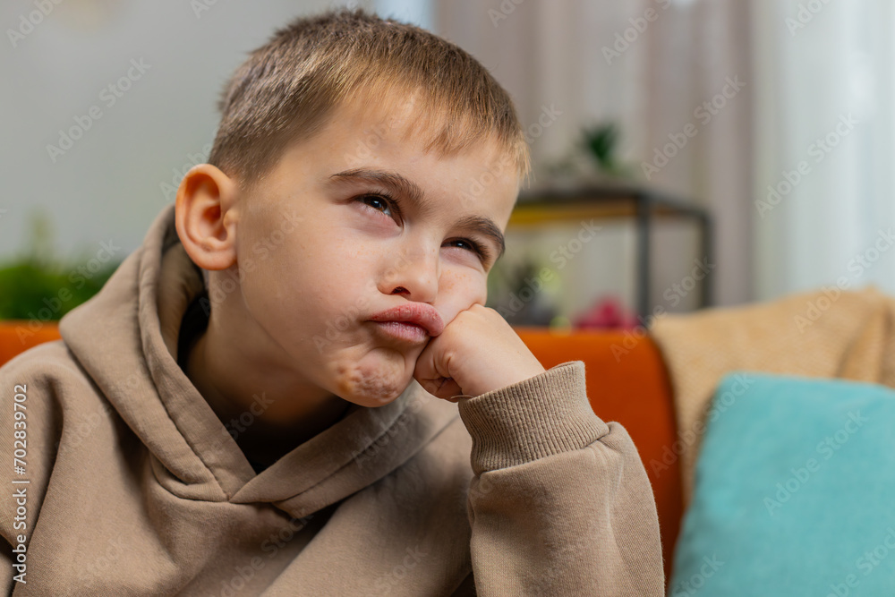 Sad unhappy preteen child boy at home looks pensive thinks over life concerns or study test exam fail, suffers from unfair situation. Teen kid problem, break up, depressed feeling bad annoyed burnout Sad unhappy preteen child boy at home looks pensive thinks over life concerns or study test exam fail, suffers from unfair situation. Teen kid problem, break up, depressed feeling bad annoyed burnout