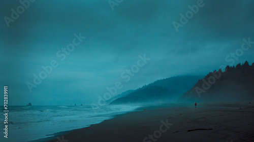 Fotografie Lonely runner in a stormy and misty beach