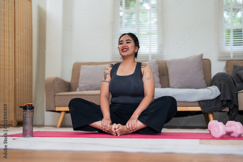 Asian overweight woman doing stretching exercise at home on fitness, Stretching training workout on yoga mat at home for good health and body shape