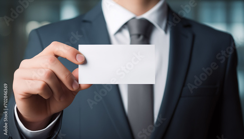 a business man is holding a blank business card