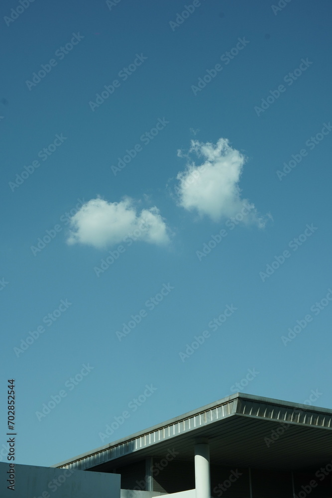 nice roof from neighbor with two clounds