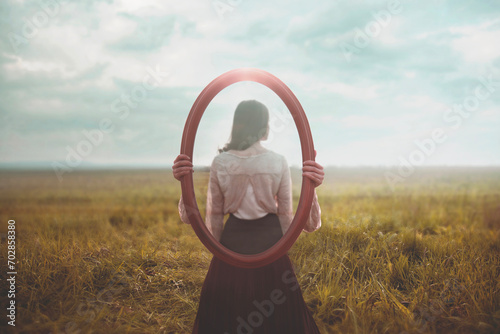 woman holding a mirror who is mirrored appears from behind, identity concept photo