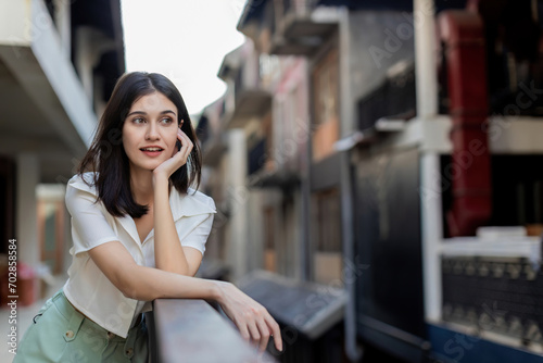 Happy Solo traveler sightseeing at An ancient town in central and park  woman solo traveling. Happy woman tourist with smiling and carefree. Excited mature female solo travel journey.