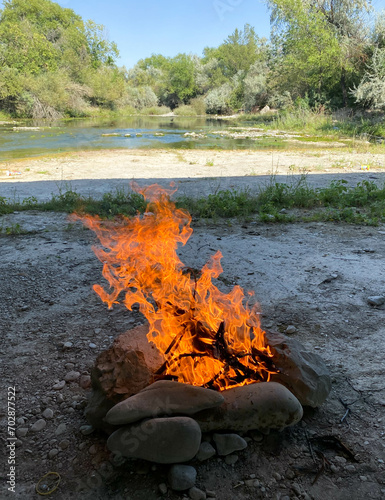 campfire in nature near the river outdoor recreation 
