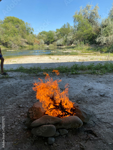 campfire in nature near the river outdoor recreation 

