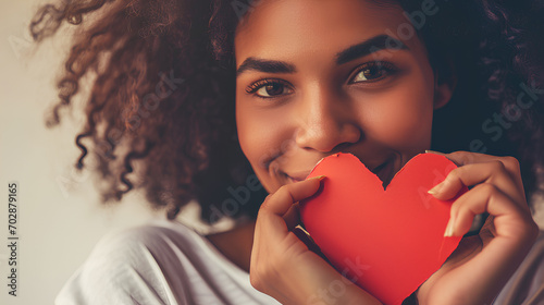 Close-up photo beautiful and amazing her dark skin lady adorable remember cuddling big paper card heart shape figure from dreamy wearing casual white t-shirt isolated yellow bright vibrant background, photo