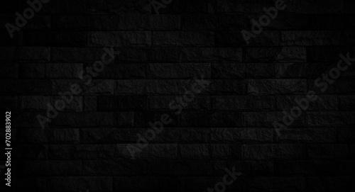 Empty black stone brick wall made with blocks for abstract  background and texture. beautiful patterns  space for work  banner  wallpaper close up  horizontal.