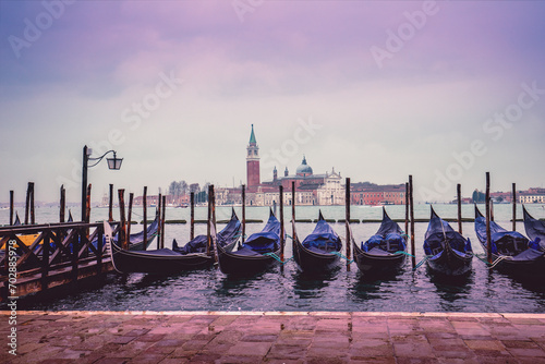 Gondolas in Venice with Abbey of San Giorgio Maggiore in the background. Ferry Gondola Pier. Venice, Italy