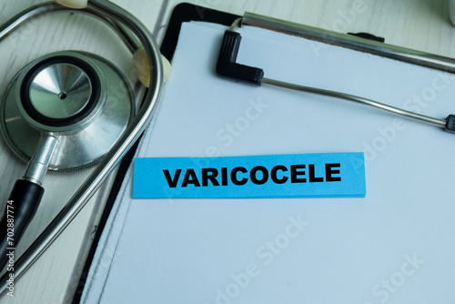 Concept of Varicocele write on sticky notes with stethoscope isolated on Wooden Table. photo