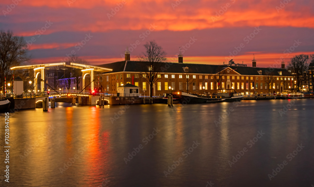 City scenic from Amsterdam at the Amstel in the Netherlands at sunset