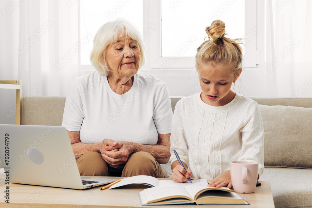 Togetherness selfie child grandmother family hugging bonding sofa laptop education granddaughter smiling Togetherness selfie child grandmother family hugging bonding sofa laptop education granddaughter smiling