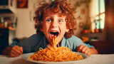 Happy boy eating tasty pasta at table in kitchen.