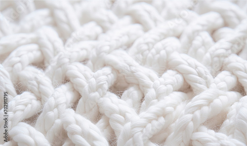 White wool handmade knitted large blanket, super chunky yarn, trendy concept. Close-up of knitted blanket, wool background