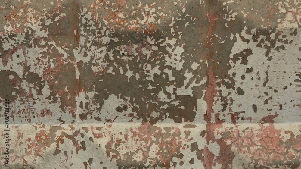 Obraz premium fragment of a concrete fence with a pattern of convex squares with flakes of peeling paint in gray-white-pink tones, a texture background of a shabby surface of a hard material with peeling old paint
