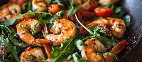 Healthy and effortless mix of shrimp, greens, and tomatoes.