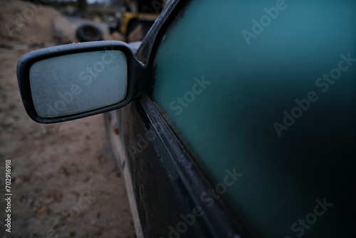 Close-up of frost covered rearview mirror of an old car.