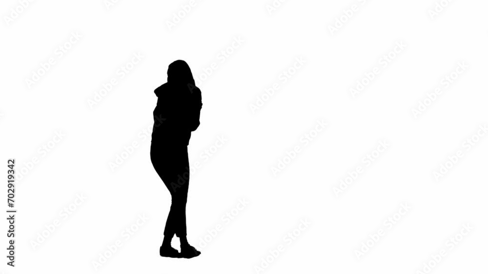 Black silhouette of a woman on a white isolated background. A young girl walks, looking around frightened, fleeing faster from danger. Side view. Black silhouette of a woman on a white isolated background. A young girl walks, looking around frightened, fleeing faster from danger. Side view.