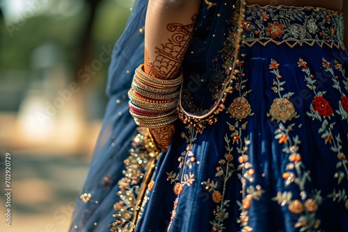 close up detail of woman wearing dark blue lehenga