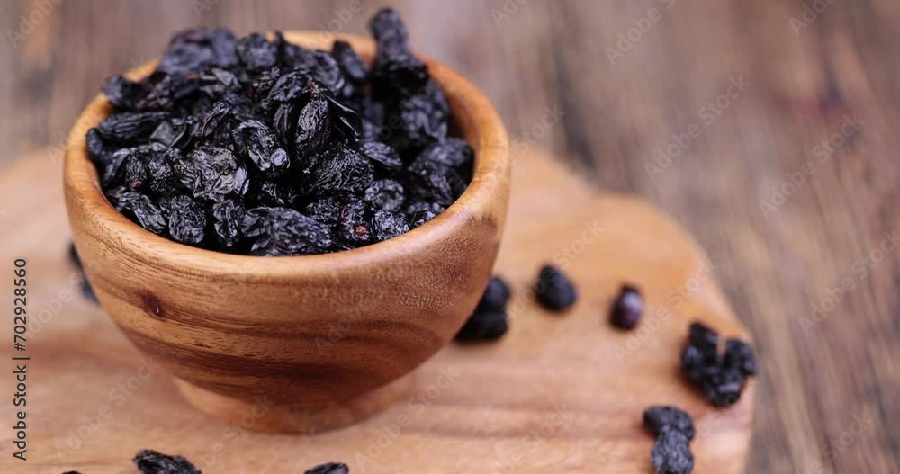 dried black raisins on the table, small dark raisins during cooking dried black raisins on the table, small dark raisins during cooking