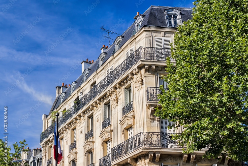 paris, frankreich - typisches pariser gebäude mit nationalflagge