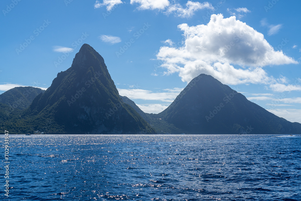 A photo of the Twin Pitons in St Lucia on a sunny day as seen from the Caribbean Sea.