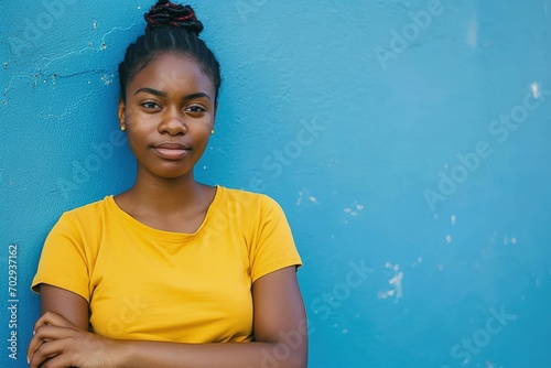 Black girl with yellow t-shirt and blue wall in the background, digital illustration, Black History Month. Generative AI