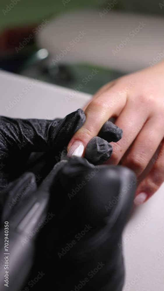 Vertical video of hardware manicure as a machine removes gel polish from nails in a detailed close-up. Vertical video of hardware manicure as a machine removes gel polish from nails in a detailed close-up.