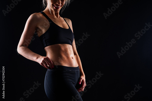 Young strong sporty athletic fitness trainer instructor woman. Workout sport concept