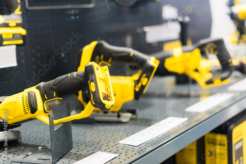Power tools  drills and hammers of various manufacturers are sold in a hardware store.