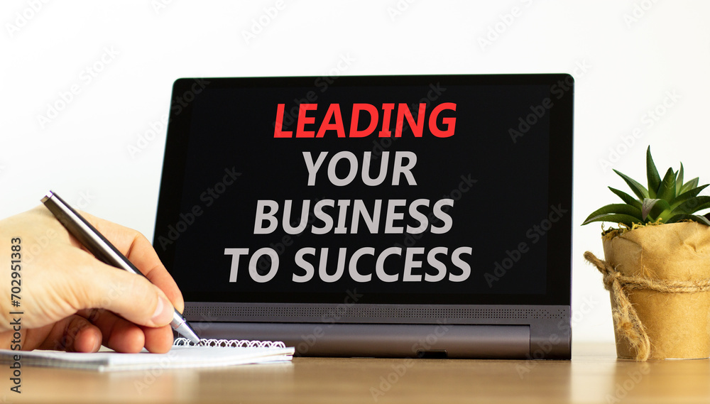 Leading your business to success symbol. Concept words Leading your business to success on beautiful black tablet. Beautiful white background. Leading your business to success concept. Copy space Leading your business to success symbol. Concept words Leading your business to success on beautiful black tablet. Beautiful white background. Leading your business to success concept. Copy space