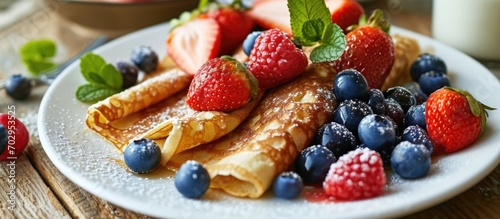 Crepe with fruits and yogurt on the table for breakfast. photo