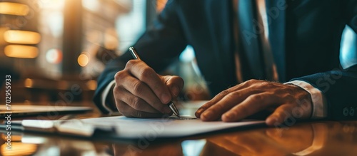 Businessman presenting pen for partner to sign contract. photo