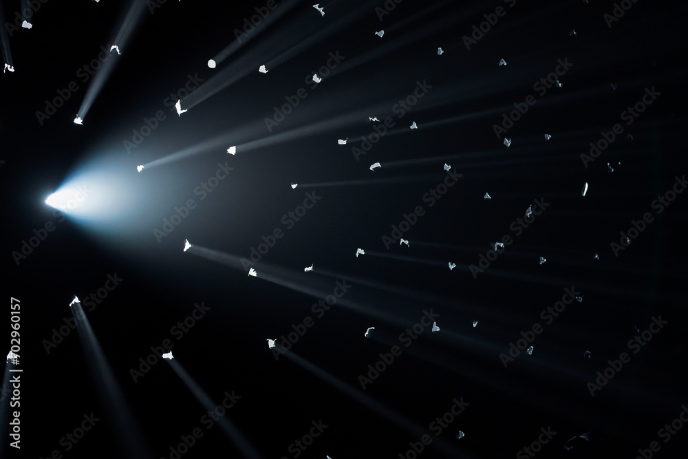 Ray Coming Back Rays of bright light come through holes in the black background of the ...