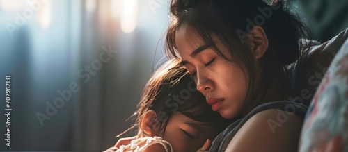Stressed single Asian mom struggling with postnatal depression and the challenges of motherhood. photo