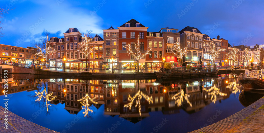 Night panorama of Leiden canal Oude Rijn in Christmas illumination, Holland, Netherlands.