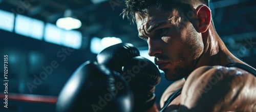 Athletic man does boxing workout in sports club.
