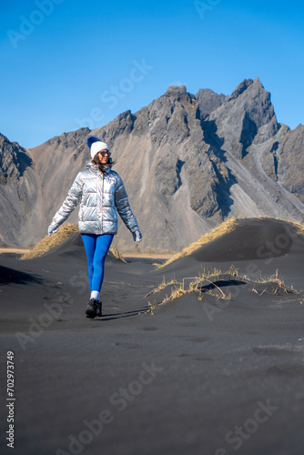 Woman walking in the dunes of Stokksnes, Iceland